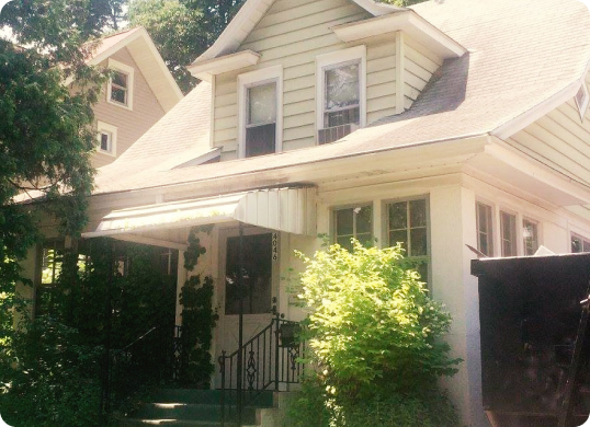 A picture of a Minneapolis home with a dumpster in the yard during a remodeling, roofing, and siding project