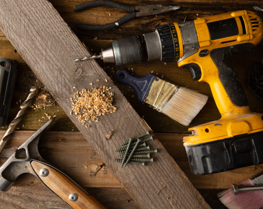 A picture of a Dewalt drill, screws, pliers, hammer and paint brush showing some of the tools needed for a great installation.
